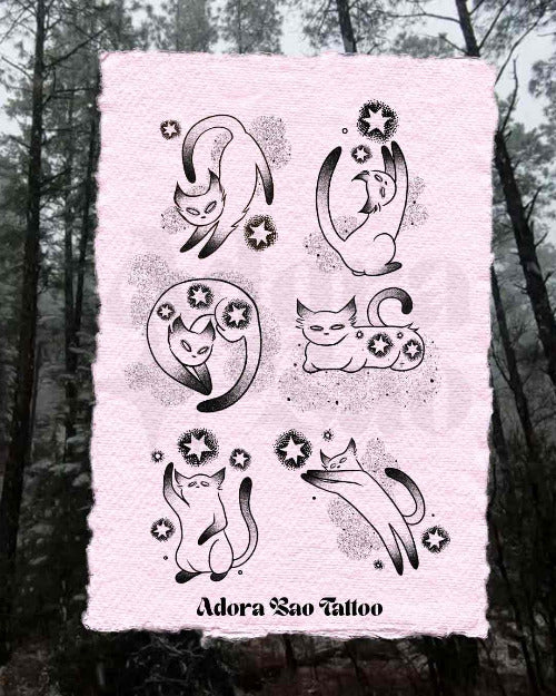 Sheet of temporary tattoos with cat designs on a textured pink paper, set against a forest background.