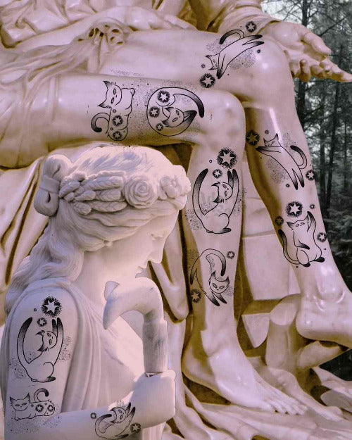 Statue with black floral tattoos on a white background